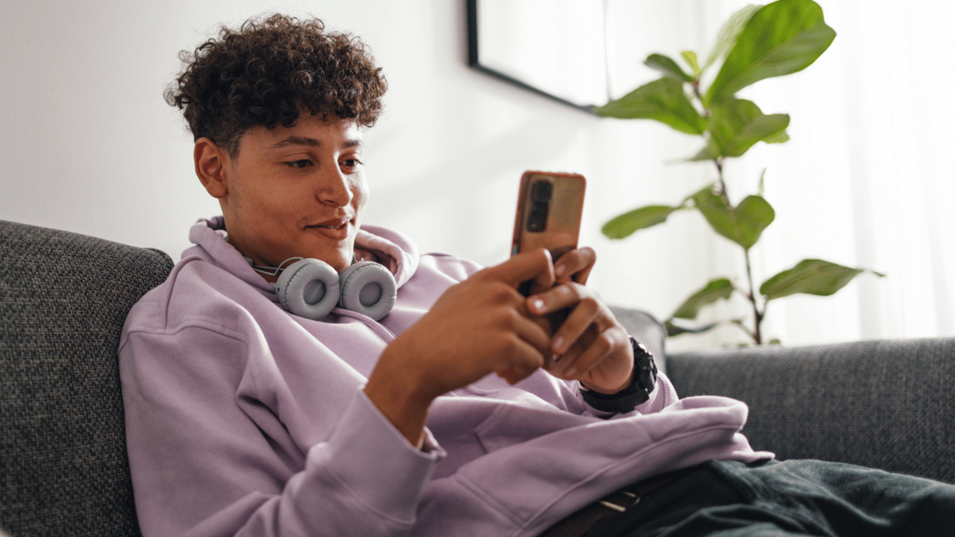 young man on phone reading